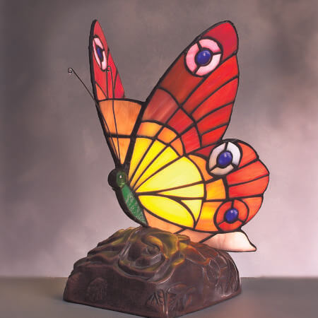 Large Tiffany Butterfly with Red and Yellow wings with jewels perched on an antique Base